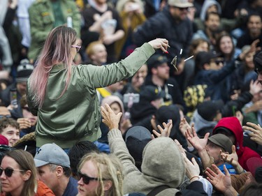 Free joints are tossed to  the cannabis enthusiasts gathered at Sunset Beach for the annual 4/20 protest in Vancouver.