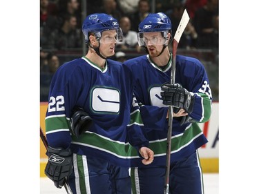 Nov. 11, 2006:  Daniel and Henrik talk before a power play during their game against the Calgary Flames at GM Place. The Flames defeated the Canucks 3-2.