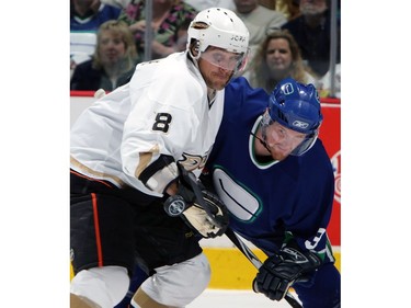 April 29, 2007:  Henrik Sedin and Teemu Selanne #8 of the Anaheim Ducks keep their eyes on a bouncing puck during game three of the 2007 Western Conference Semifinals at GM PLace.