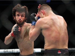 Zabit Magomedsharipov (L) throws a left hand at Kyle Bochniak (R) during their featherweight bout at UFC 223 at Barclays Center on April 7, 2018 in New York City.