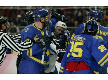 Feb. 19, 2006: TURIN, ITALY - FEBRUARY 19:  Henrik Sedin #20 of Sweden and Scott Gomez #11 of the United States scuffle during the men's ice hockey Preliminary Round Group B match during Day 9 of the Turin 2006 Winter Olympic Games on February 19, 2006 at the Torino Esposizioni in Turin, Italy.