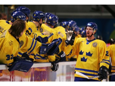 Feb. 22, 2006:  Henrik Sedin #20 of Sweden is congratulated by teammates after his first period goal to take a 1-0 lead over Switzerland during the quarter final of the men's ice hockey match during Day 12 of the Turin 2006 Winter Olympic Games on February 22, 2006 at the Torino Esposizioni in Turin, Italy.