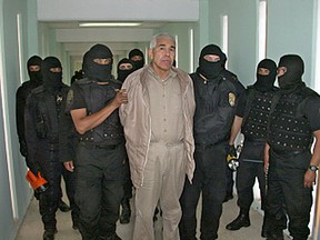 In this file photo taken on January 27, 2005, shows members of the Mexican Federal Preventive Police (PFP) guarding drug trafficker Rafael Caro Quintero (C), after an operation in the "Puente Grande" prison, in Guadalajara, Jalisco, 450 km west of Mexico City.