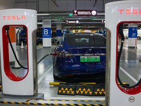 A Tesla vehicle is parked at a charging station inside a mall in Shanghai.