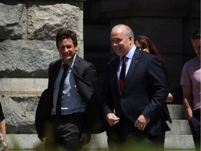 B.C. Education Minister Rob Fleming walks with Premier John Horgan in Victoria.