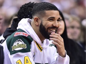 Rapper Drake, watches first half round one NBA playoff basketball action between the Toronto Raptors and Washington Wizards in Toronto on Saturday, April 14, 2018.