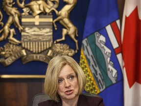 Alberta Premier Rachel Notley talks to cabinet members about the Kinder Morgan pipeline expansion in Edmonton on Monday, April 9, 2018.THE CANADIAN PRESS/Jason Franson