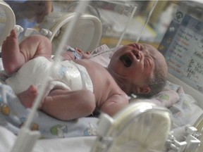 A newborn baby, one of 12 babies born by C-section, cries inside an incubator at the Bunda Hospital in Jakarta on December 12, 2012.  Several hospitals in Indonesia's main cities performed more Caesarians than usual with new mothers hoping a 12-12-12 birth date will bring luck to their newborns.