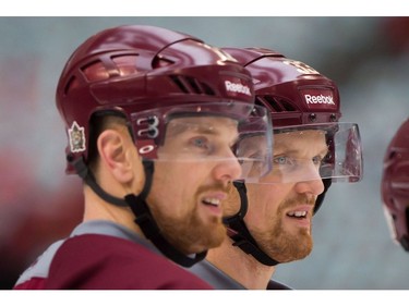 March 1, 2014: Vancouver Canucks' Henrik Sedin, right, and his twin brother Daniel Sedin, both of Sweden, look on during practice for the Heritage Classic NHL hockey game at B.C. Place