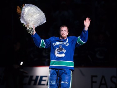 Dec. 2, 2017 -- Vancouver Canucks' Daniel Sedin, of Sweden, waves to the crowd as he's honoured for recently recording his 1,000th career point, before an NHL hockey game against the Toronto Maple Leafs.