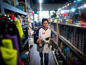 Jennifer Pinch, who organized Jersey Day, which encourages people to wear a sports jersey, hockey or otherwise on Thursday in support of the Humboldt Broncos hockey team, works in the pet supply she owns in Langley, B.C., on Wednesday April 11, 2018.