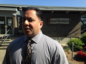Former Abbotsford police officer Ravinder "Rob" Thandi is suing the APD for failing to consider his mental illnesses while investigating him for fraud. In this file photo from 2015, Thandi stands outside the Abbotsford courthouse after his sentencing hearing.