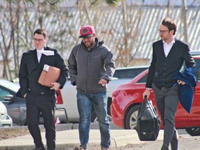 Jason Gourlay (centre) walks into the Kamloops Law Courts on Wednesday with lawyers Jeremy Jensen (right) and Marshall Putnam.
