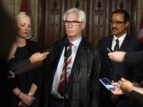 Minister of Natural Resources Jim Carr speaks to reporters with Minister of Environment and Climate Change Catherine McKenna and Minister of Infrastructure and Communities Amarjeet Sohi, after an emergency cabinet meeting on Parliament Hill in Ottawa on Tuesday, April 10, 2018.
