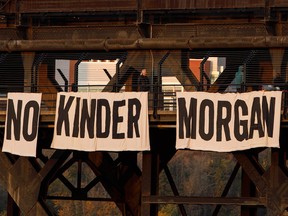 An anti-pipeline message on a banner hangs from a bridge in Edmonton, Alta.
