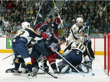 Jan. 25, 2004:  Todd Bertuzzi #44 of the Vancouver Canucks celebrates the goal of teammate Henrik Sedin #33 after shooting the puck past Tomas Vokoun #29 of the Nashville Predators as Vladimir Orszagh #33 and Andrew Hutchinson #42 of the Predators look on during the second period at GM Place.
