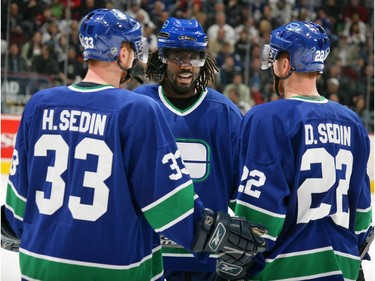 Jan. 10, 2006:  Anson Carter #77 of the Vancouver Canucks talks to linemates Daniel Sedin  and Henrik Sedin during their game against the Toronto Maple Leafs at GM Place. The Canucks defeated the Maple Leafs 4-3.