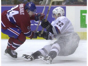 Jan. 3, 2002: Canucks' left winger Daniel Sedin (22) is knocked down by Montreal Canadiens' center Yanic Perreault (94) during first period.