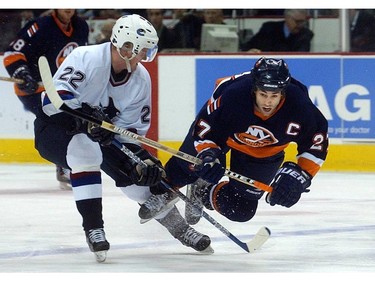 Mar. 11, 2003: New York Islanders'  center Michael Peca (27) takes a dive in front of  Vancouver Canucks'  left winger Daniel Sedin (22) during second period.