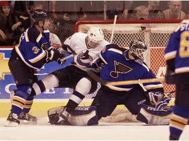 March 13, 2003: Daniel Sedin is pushed into St. Louis Blues goalie Brent Johnson by Eric Boguniecki.