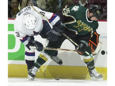 March 28 2001:   Henrik Sedin and Dallas Stars Jamie Langenbrunner battle for the puck at GM Place.