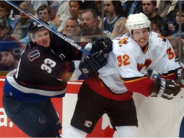 April 9, 2004: Center Henrik Sedin (33) chases   Calgary Flames' defenceman Toni Lydman (32) during third period Game two Western Conference playoff.