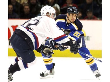 Apr. 10, 2003: Daniel Sedin (#22) tries stick check St. Louis Blues' Bryce Salvador (#27) during the first period in NHL first round playoff action at GM Place in Vancouver.