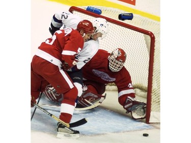 Apr. 21, 2002: Daniel Sedin (#22) battles for the puck with Detroit Red Wings Nicklas Lidstrom (#5) while trying to put it past goalie Dominik Hasek (#39) during second period at GM Place. Canucks lead the Red Wings 2 games to none in the first round of Western Conference Stanley Cup playoffs.
