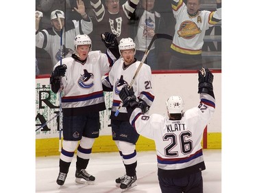 Apr. 22, 2003: Henrik Sedin (#33) celebrates his goal with twin brother Daniel Sedin (#22) and Trent Klatt (#26) against the St. Louis Blues during the first period of game seven in NHL first round playoff action at GM Place.