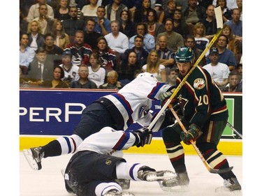 May 8, 2003: Vancouver Canucks Henrik Sedin (top) and Todd Bertuzzi (bottom) are knocked to the ice by  Minnesota Wild Andrei Zyuzin (#20) during the third period of game seven in the best of seven game Western Conference semi-final series of the NHL Stanley Cup playoffs at GM Place.
