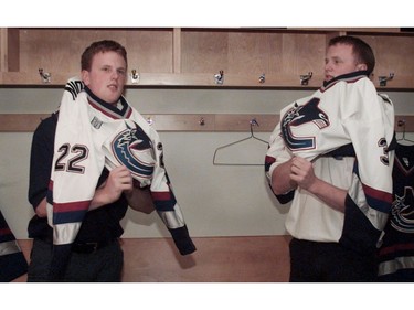 July 5, 2000 --  The Vancouver Canucks introduced the Sedin twins to the local media. .  L-R) Daniel and Hendrik try on their jerseys.