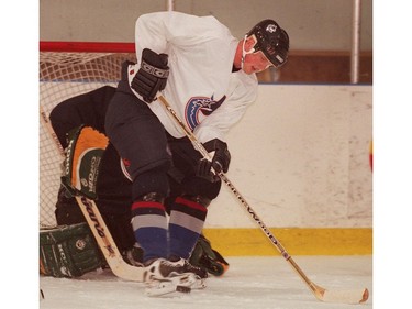 July 7, 2000:  Daniel  Sedin kicks the puck forward in front of the net during an on ice session at the Twist training camp.