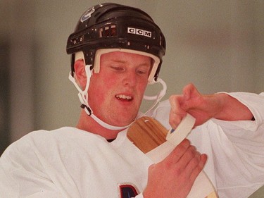 July 7, 2000 --Daniel Sedin retapes his stick during an on ice session at the Twist training camp.