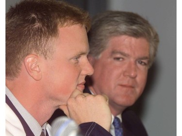 July 27, 1999: Newly signed Vancouver Canuck Henrik Sedin with Canucks GM Brian Burke during  a news conference in Vancouver. The twin brothers said they will not play in the NHL this season. They will return to play in Sweden for one more year.