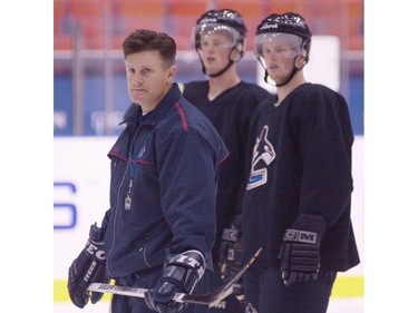 Sept. 11, 2000: The Sedin twins watch as  Vancouver Canucks coach Marc Crawford runs the team through a few plays during practise at the Hovet arena in Stockholm.