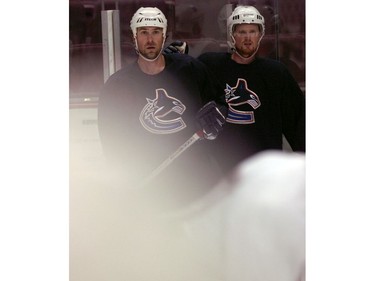 Sept. 12, 2005: Vancouver Canucks training camp first on-ice session for veteran players at GM Place. Pictured is Trevor Linden, left, and Henrik Sedin watch as a blur of motion of players skate by during practice.