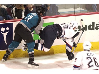 Oct. 6 200: Vancouver Canucks vs San Jose Sharks.  Shark Toidd Harvey checks Canuck Henrik Sedin.