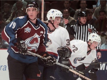Oct. 12, 2000: Colorado Avalanche forward Joe Sakic skates up the ice with Vancouver Canuck twin brothers Henrik Sedin (center) and Daniel Sedin (R)