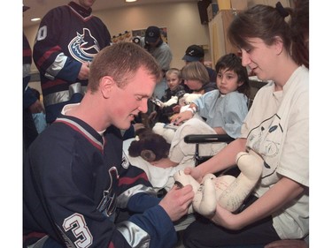 Dec. 13, 2000  --Vancouver Canucks paid  their annual Christmas visit to The Children's Hospital cheering sick kids with with gifts of teddy bears and signed hockey cards.