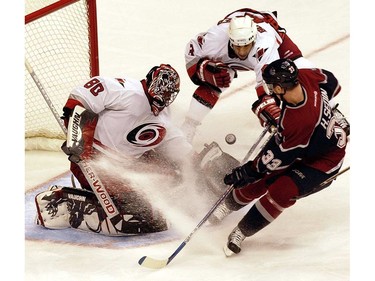 Dec. 14, 2003: Henrik Sedin follows his shot in on Carolina Hurricanes' goalie Kevin Weekes during the third period at GM Place.