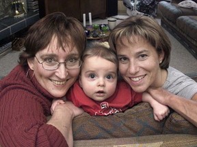 Seven-month old Evan in 2002 with his mother, Terri Rypkema, left, and Selina Robinson, right. Selina carried Evan, who is Terri and husband Paul's genetic child as a surrogate mother.