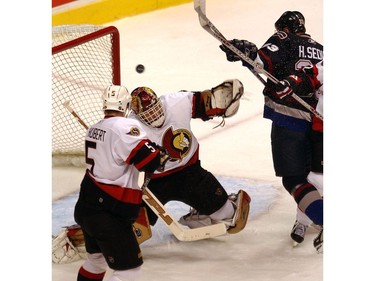 Dec. 9, 2005: Henrik Sedin gets close in shot against  Ottawa Senators Dominik Hasek.