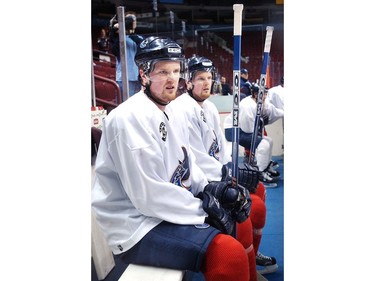 Mar. 25, 2004: Daniel and Henrik Sedin rest briefly on the bench during shifts with the team during practice.