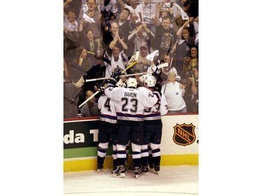 May 8, 2003.   Daniel and Henrik Sedin and Nolan Baumgartner and Murray Baron race toward teammate Todd Bertuzzi after he scored the second goal against the Minnesota Wild.