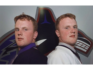 July 27, 1999: Not this year. Daniel (L) and Henrik (R) Sedin pose for photographs after a press conference at GM Place where GM Brian Burke announced that the club has its 1999 draft picks under contract. The twins will most likely spend this year in the Swedish Elite league before joining the NHL team next season.