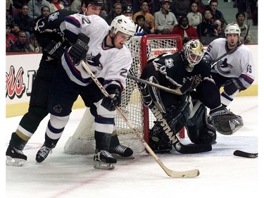 Dec. 2, 2001 - Vancouver, B.C - Vancouver Canucks #22 Daniel Sedin tries in vain to get the puck in the net while Dallas Stars #2 Derian Hatcher holds him back in the second period of the game held at G.M Place. (Denise Howard/Vancouver Sun) [PNG Merlin Archive]