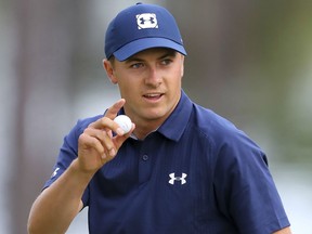 Jordan Spieth waves after making a birdie putt on the 16th hole during the first round of the Masters golf tournament Thursday in Augusta, Ga.