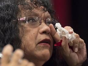 Trudy Smith wipes a tear during her testimony about her murdered sister Pauline Johnson during the national inquiry of missing and murdered Indigenous women and girls in Richmond,.