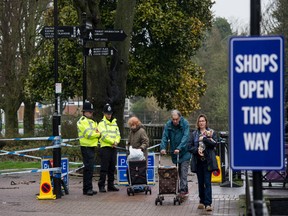 Police officers stand at a cordon near the scene where former double-agent Sergei Skripal and his daughter, Yulia were discovered after being attacked with a nerve-agent amid continuing investigations on April 10, 2018 in Salisbury, England.