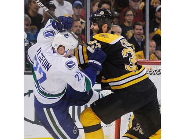 JUNE 13, 2011 -- Vancouver Canucks Daniel Sedin (left) collides with Boston Bruins Zdeno Chara (right) during the first period of game six in the 2011 NHL Stanley Cup final at TD Garden in Boston, MA.